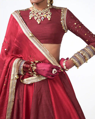 Detailed close-up of applique trims and shimmering crystal detailing on the Deewani Lehenga blouse, crafted for bridal and wedding celebrations.