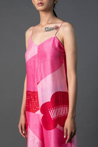 Detailed shot of sparkling sequin embellishments on fuchsia evening jumpsuit.