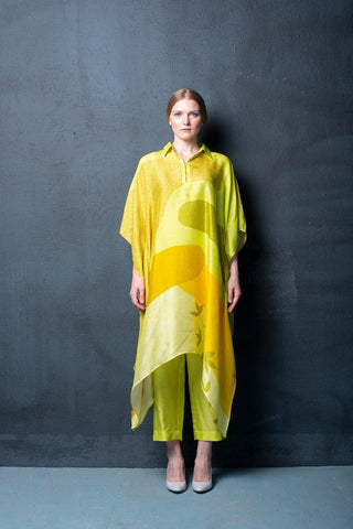 Two-piece yellowish green dupion silk set featuring geometric abstract print kurta with asymmetrical hemline and parallel pants. Perfect for brunch, evening gatherings and daytime wear. Designed by Clos.