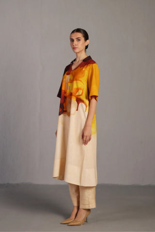 Ochre shade kurta set styled for casual social gatherings, featuring relaxed short sleeves, straight pants, and airy Korean linen fabric with painterly colour application.
