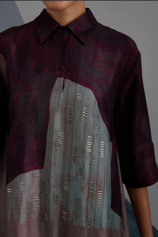 Close up of geometric Omen print and embellishments on silk tunic.