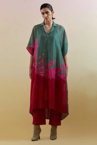 Green and pink linen silk kurta/tunic set with asymmetrical high-low hem and straight trousers. Contemporary ethnic women's wear for festive gatherings and cultural events. Designed by Clos.