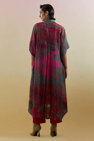 Back look of green and pink kurta set showcasing high-low hemline and short sleeves.