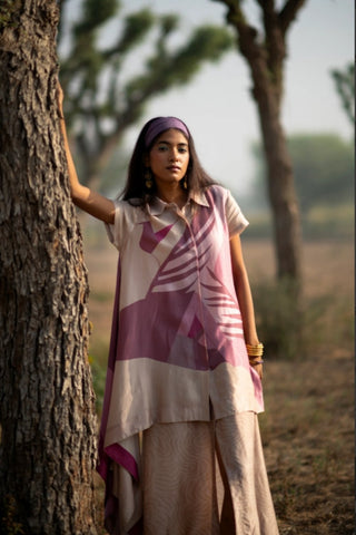 Two-piece co-ord set with asymmetric top and straight center slit skirt in rich Japanese plant-based fabric, offering a refined texture and fluid drape. Paired with a straight skirt designed with a center slit.