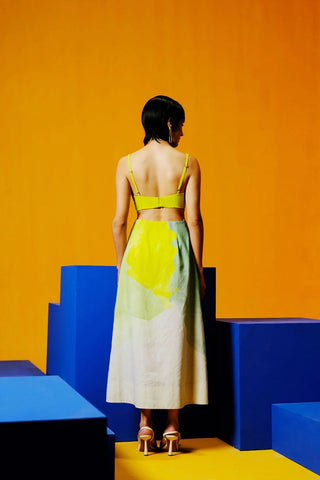 Back look of designer A-line dress in neon green and blue, featuring padded cups, side cut-outs, and a fluid silhouette in lightweight Korean linen.