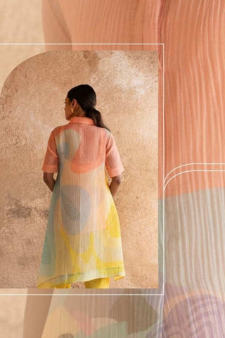 Back view of peach yellow three-piece set showcasing clean lines and asymmetric pattern placement.