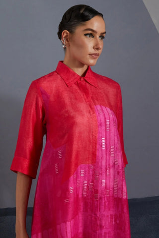 Close up of geometric Omen print and embellishments on pink tunic.