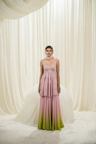 Elegant festive peplum sharara set in baby pink with scallop detailing and silver embroidery, perfect for weddings and special occasions.