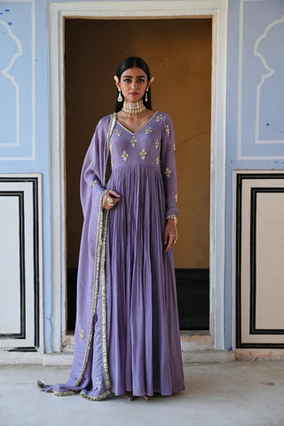Designer lilac V-neck floor-length Anarkali featuring intricate floral butti embroidery, full sleeves, and a coordinated dupatta for a regal finish. Designed by ease.
