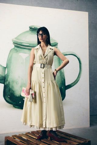Elegant ivory dress featuring a structured collar, subtle embroidered yoke, and adjustable tie-up belt. A timeless silhouette that blends comfort and sophistication for modern everyday fashion.