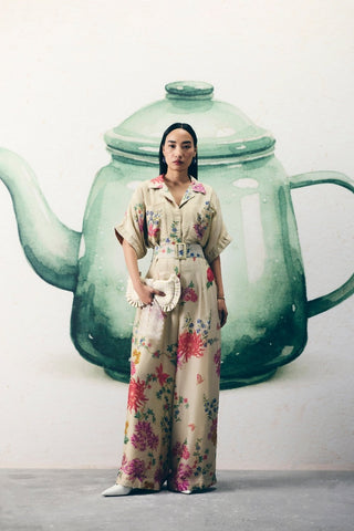 Ivory collared jumpsuit with delicate embroidered pockets and a tie-up belt for a flattering fit. A refined and elegant outfit ideal for day outings, brunches, or effortless chic styling.