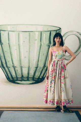Hanami Off White Maxi Dress crafted in soft poplin featuring delicate ivory floral prints, a fitted bust, side zip closure, and a matching modal silk tie-up belt. An elegant women's maxi dress perfect for summer outings, brunches, and special occasions.