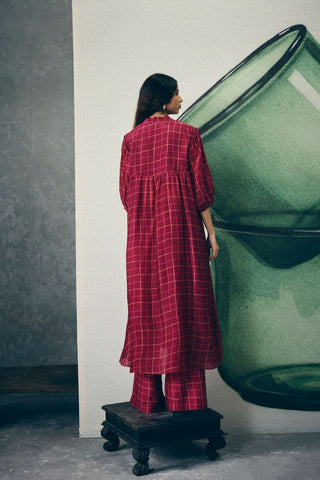 Back look wine blazer set with delicate embroidery, styled with pants and a maroon checked kurta with printed bottoms. A sophisticated outfit that can be elevated with a scarf for a chic finish.