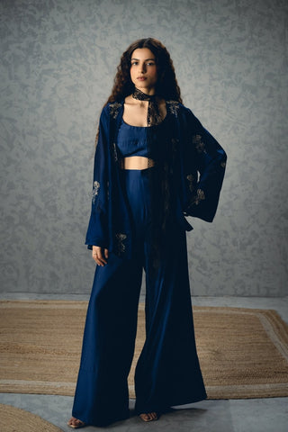 Navy blue silk co-ord set with a structured bustier and tailored pants, layered with a bell-sleeve jacket featuring minimal embroidery. A refined and elegant look for evening or festive wear.