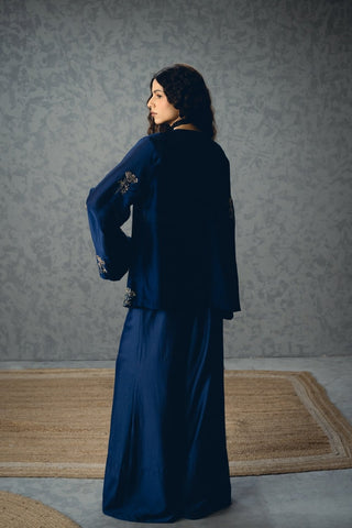 Back look chic navy blue three-piece silk set with a fitted bustier, sleek pants, and a lightly embroidered bell-sleeve jacket. Perfect for modern festive styling with understated elegance.