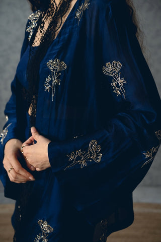 Elegant navy blue outfit in pure sarthak silk featuring a bustier and pants, styled with a flowy bell-sleeve jacket with subtle embroidery for a polished and sophisticated appearance.