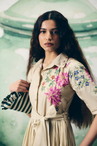 Detailed close-up of floral placement print and delicate embroidery on the collared neckline.