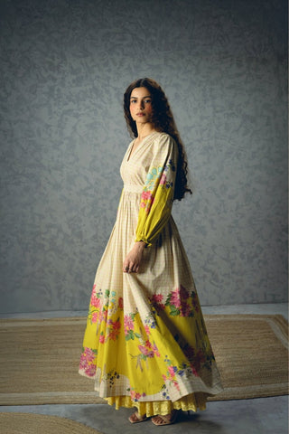 Designer Elena Dress showcasing an ivory floral print with bright yellow blooms, lightweight poplin fabric, puff sleeves, and a flattering fitted silhouette. A versatile women's outfit for brunches, vacations, celebrations, and seasonal events.
