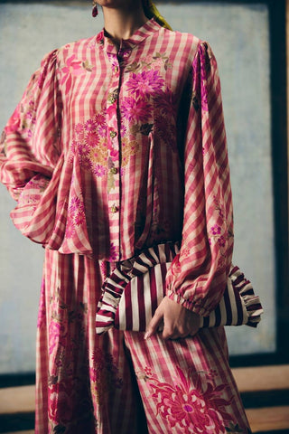 Close up of pink gingham co-ord set featuring a flowy godet shirt and matching printed pants. A fresh and vibrant outfit designed for relaxed yet polished everyday fashion.