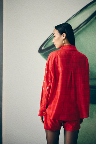 Stylish red checked shorts set with a coordinated bustier and embroidered shirt. A modern and youthful look perfect for creating a statement outfit with effortless elegance.