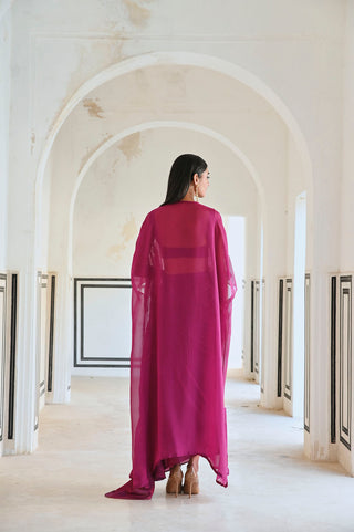 Back Look of 3-piece magenta bralet, cowl skirt and sheer embroidered jacket set.