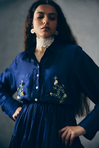 Model posing and giving a close up look in Navy blue seiu shirt with emboridery.