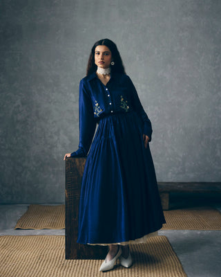 Model posing in charming Navy Blue midi dress designed with pocket embroidery offering a lend of comfort and subtle sophistication. Designed by Ease. Pefect dress for parties, evening soiree, office, everyday, casual, holiday vacation or for resort.