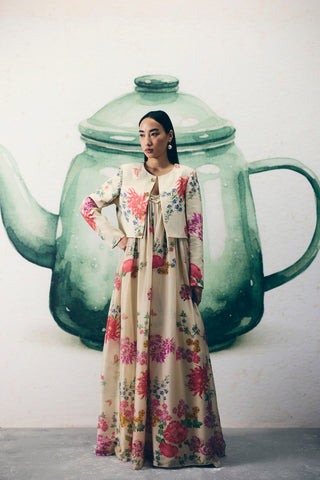 Woman in Ivory floral organza silk jumpsuit and jacket with a flowy silhouette, perfect for party wear, formal events, resort looks, vacation styling, holiday outfits, soirées, and wedding receptions. Designed by Paulmi and Harsh and Ease. Shop this elegant statement jumpsuit online.