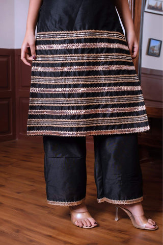 Close up of golden patti work on black taffeta silk kurta set by Ghazal, highlighting intricate detailing and craftsmanship in women’s designer festive ethnic wear