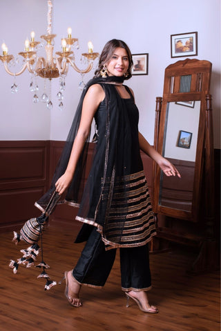 Side angle of black taffeta silk kurta set with golden patti work by Ghazal, women’s ethnic outfit showcasing fabric structure and flow, ideal for festive wear and celebrations.