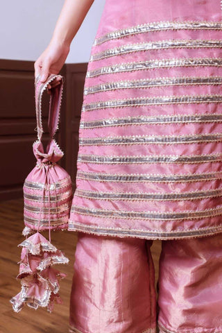 Close up of golden patti work on peach taffeta silk kurta set by Ghazal, highlighting intricate detailing and craftsmanship in women’s designer festive ethnic wear.