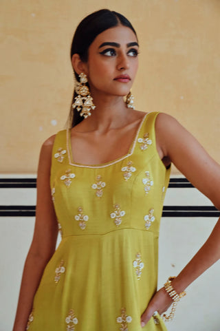 Close-up of the floral butti embroidery on the lime sleeveless jumpsuit's square neckline.