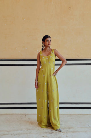 Full-length styled look of the lime jumpsuit, a festive statement piece in silk.