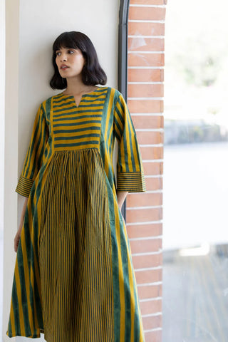 Model wearing mustard and green striped 4 panel cotton kurta with notch neckline and three-quarter sleeves