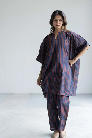 Model wearing navy and rust striped cotton kaftan top with matching straight pants. Women's navy and rust striped kaftan co-ord set with matching pants, a relaxed Indian-inspired outfit for travel, holidays and casual occasions.