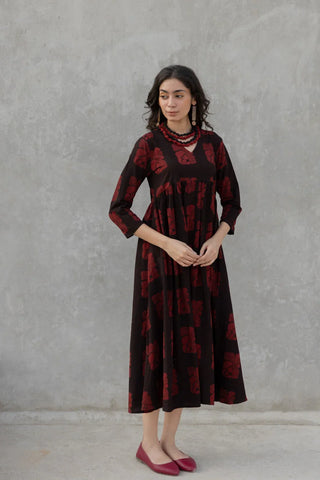 Vrajbhoomi Orah V neck flared dress in hand-block-printed cotton, featuring a flowing full-length silhouette and practical side pockets. Designed for relaxed daytime dressing and casual outings.