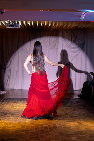 Back shot of crimson red chiffon ruffle pre-drapped pre-stitched saree, paired with a silk hand-embroidered blouse at Australian Fashion Grandeur runway.