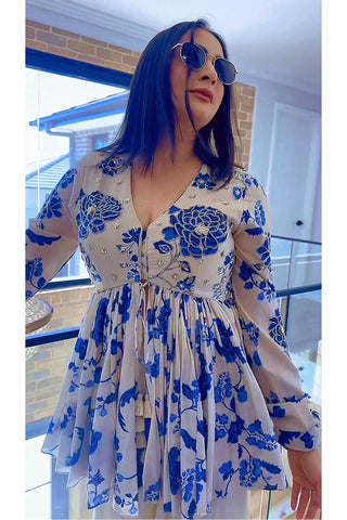 A close up look of the floral paulmi and harsh signature print with embroidery with palazzo. Woman is all ready for festive forward parties.