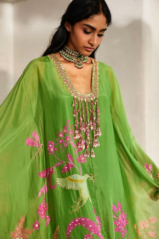Detailed close-up of the heavily embroidered neckline, floral print, intricate threadwork, and hand-tucked tassels.