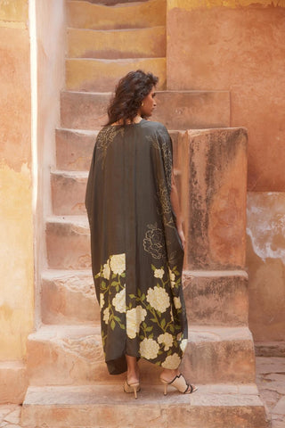 Back look of floral silk kaftan featuring a modern knot detail and solid black slip, blending comfort with contemporary elegance.