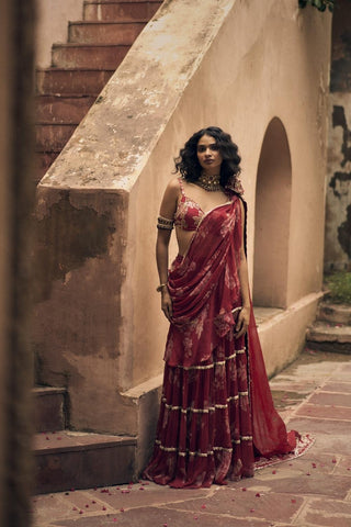 Elegant vintage-style pre-draped chiffon saree featuring soft floral prints and intricate hand-embroidered lace, paired with a bralette-style blouse. Designed by Paulmi and Harsh.