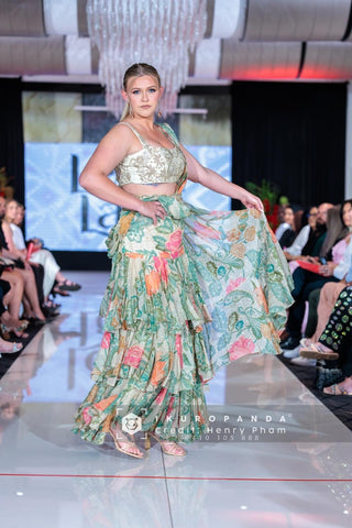 Model in Designer green floral chiffon saree with pre-draped styling and detailed lace embroidery.