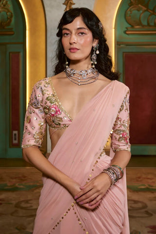 Signature Paulmi and Harsh printed blouse in rose gold embroidery paired with pink pre-stitched cocktail saree.