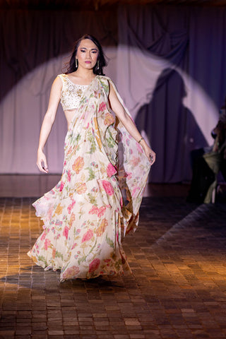Model draped in a flowing chintz and bird printed pre-draped saree with belt and blouse in off-white colour at Australian Fashion Grandeur runway.