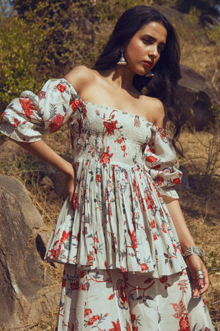 Off-white bird printed peplum top with bishop sleeves and gathered detailing, paired with matching printed palazzo pants. Perfect of Summer, Resort wear, brunch, evening parties.