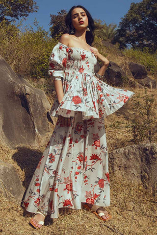 Off-white bird printed peplum top with bishop sleeves and gathered detailing, paired with matching printed palazzo pants.