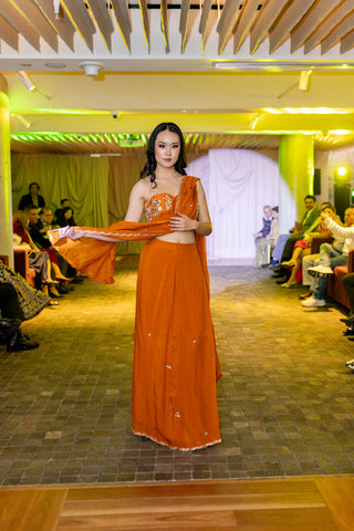 Model draped in delicate organza pre-draped saree, with hand-embroidered all-over buttis and scallops at Australian Fashion Grandeur.