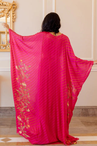 Back look of pink kaftan set. Flowy rani pink leheriya kaftan with floral design, perfect for resort wear and holiday styling.