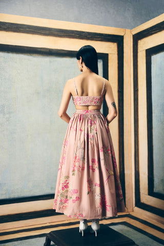 Back look of Alina designer skirt set pairs a delicately embroidered bustier with a relaxed organza shirt and floral skirt for refined festive and occasion dressing.