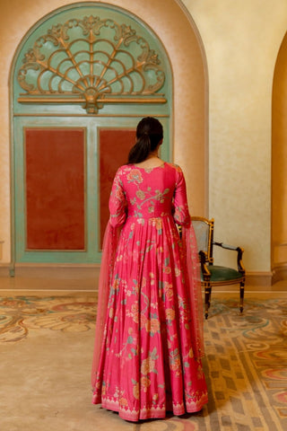 Back look of soft blooming pink floral Anarkali with V-neckline and detailed hand embellishments, styled with a net embroidered dupatta for a contemporary feminine look.